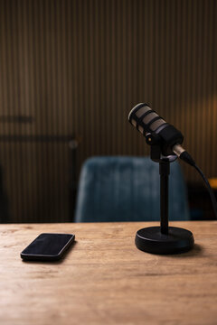 Mobile phone by microphone on desk in recording studio