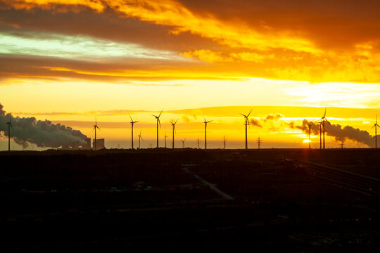 Garzweiler brown coal mining at sunrise with wind park in the background, Juechen, Germany