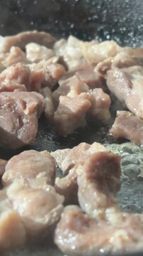 Frying meat pieces with steam in pan for laghman and Central Asian noodle dishes



