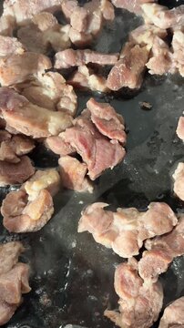 Frying meat pieces with steam in pan for laghman and Central Asian noodle dishes



