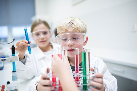 Students conducting experiments with test tubes during a science lesson
