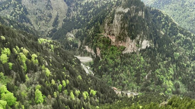 Majestic view of Sumela Monastery nestled in the steep cliffs of Trabzon, Turkey. Ancient Greek Orthodox monastery in Macka, cinematic 4K drone footage.