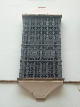 Traditional window with black ornate wrought iron grille in Albaicin, Granada, Andalusia, Spain