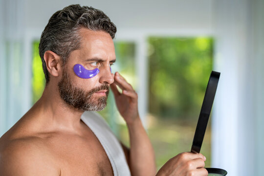 Man use eye patch. Vitamin collagen patches. Eye patch. Beauty man face with under eye collagen pads. Skin with moisturizing patches under eyes. Beauty skin cosmetology. Skin cosmetics spa