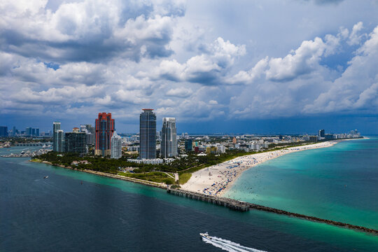 Luxury yacht cruising near Miami skyline. Aerial view of boats on turquoise waters in Miami. Yacht retreat in South Florida Miami.