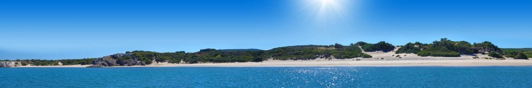 Landscape panorama showing a view from the sea of a beautiful, deserted sandy beach "Agios Georgios" in the southwest of the island of Rhodes in Greece