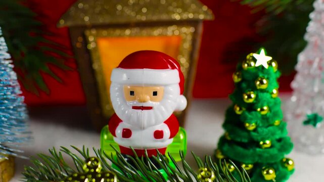 Close-up of Santa Claus with letters and Christmas tree branch against the background of a Christmas lantern