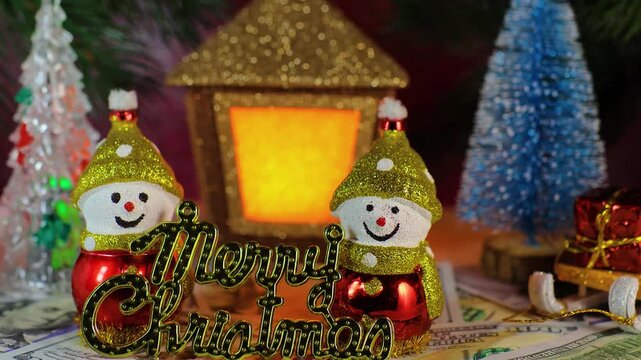 Among the Christmas trees are two snowmen with dollars and letters against the backdrop of a Christmas lantern