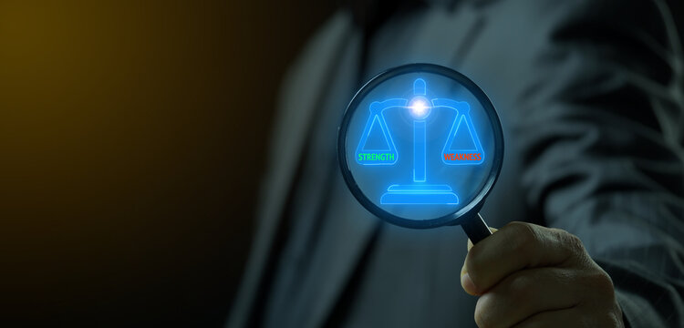 Hand with magnifying glass searching glowing justice scales with strength and weakness text. Business SWOT analysis concept.