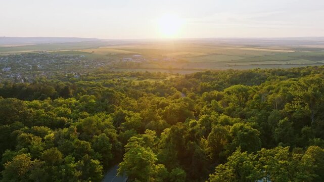 Madara village green forest valley panoramic drone view sunset golden hour warm sun light fields summer travel tourism exploration real real estate advertising background Bulgaria.