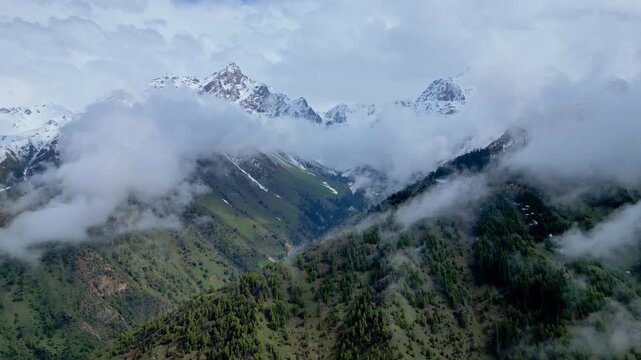 Snow Mountain Scenery. Snowcapped Summits Beneath Clouds Displaying Icy Slopes And Deep Crevasses