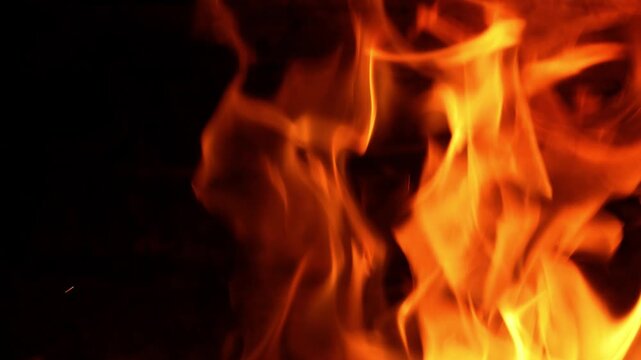 High-quality 4K video at 50fps showing roaring orange flames consuming firewood inside a rustic oven. High frame rate allows for smooth slow motion or real-time playback