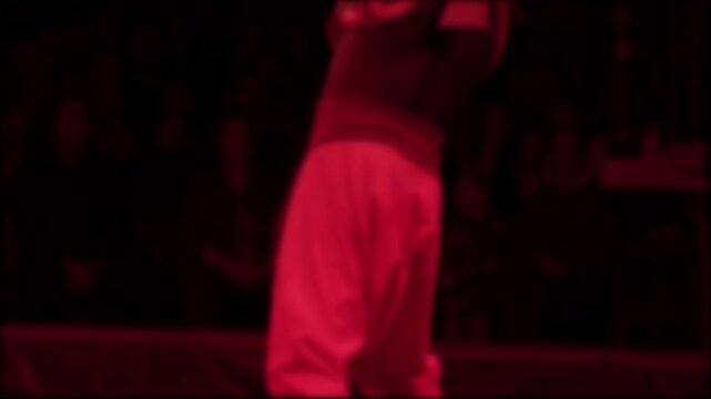 Dynamic fire performance by one person at circus event, creating blurred light trails and dramatic visual effect against dark background, captured in mesmerizing, slow motion, blurry