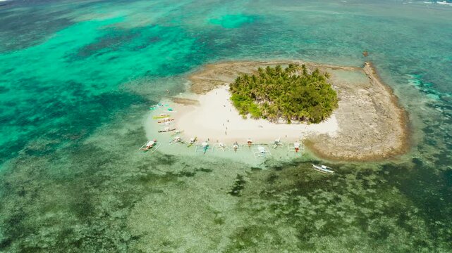 Travel concept: sandy beach on a small island by coral reef atoll from above. Guyam island, Philippines, Siargao. Summer and travel vacation concept.