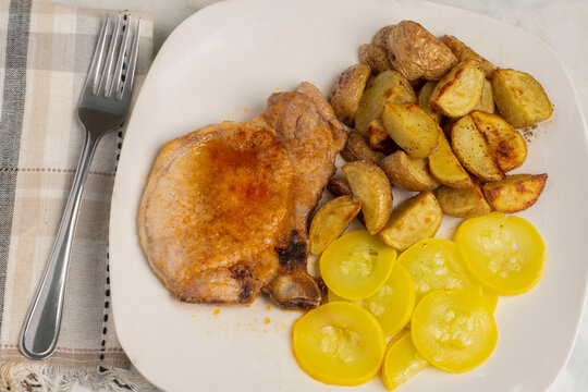 pork chop with potatoes and  summer squash