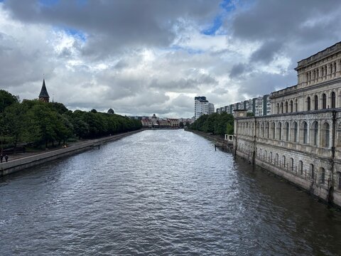 Scenic river view with historic buildings and cloudy sky  