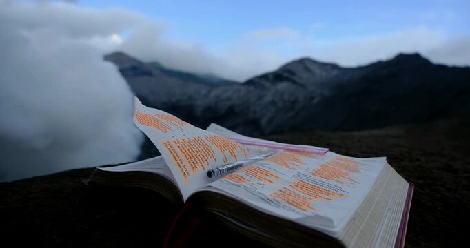 Holy Bible on Volcanic Mountain With Dramatic Clouds in East Java