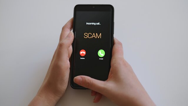 Close-up of smartphone screen displaying dangerous incoming scam call.