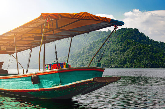 Traditional Fishing Boat on Peaceful Lake in Asia at Sunrise