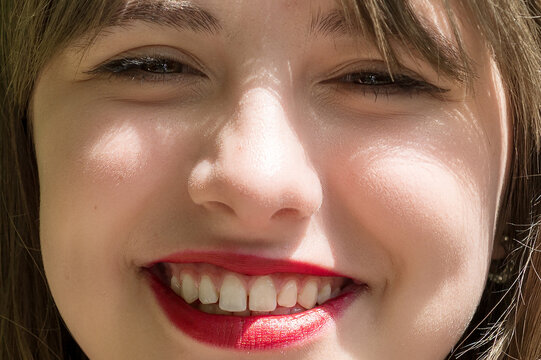 Close Up Portrait of Happy Smiling Young Woman Looking at Camera