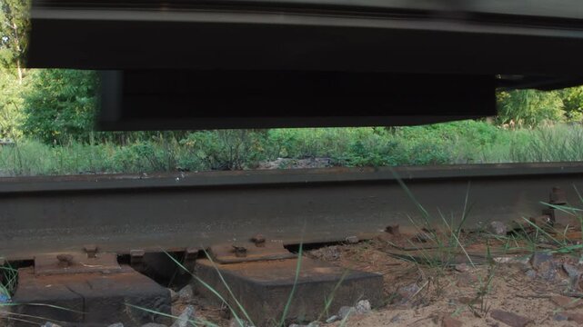 Freight Rail Transport. Loop. Close-up of the rails and sleepers on which the wheel sets of a diesel locomotive and wagons pass