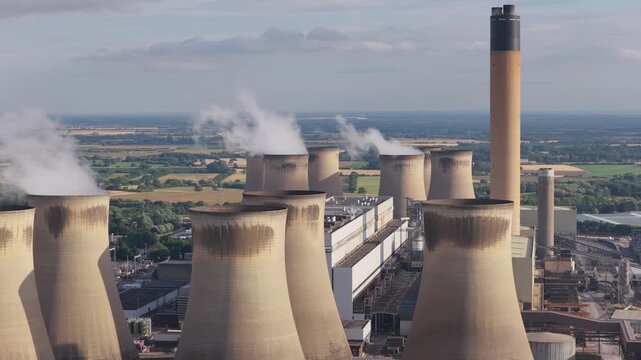 Cooling Towers at Large Power Station in Rural Area Emit Steam During Daytime