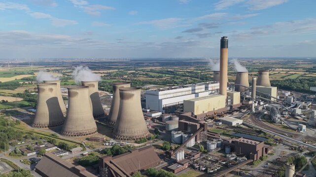Steam Rises From Power Station Cooling Towers on a Bright Sunny Day