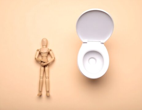 下痢の辛さに耐えかね腹を押さえる