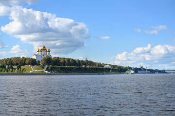 View of the Volga River embankment with the golden domes of the medieval Assumption Cathedral and white stairs descending to the river in Yaroslavl, Russia © Sergey
