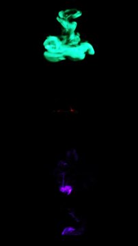 Abstract colorful smoke plumes rising and swirling against a dark background