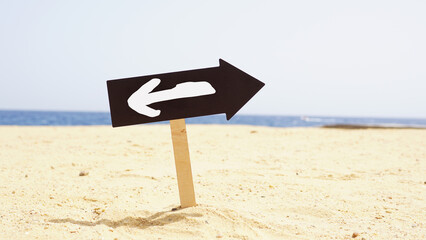 Change to Opposite Direction Sign on Sandy Beach Symbolizing Business Decision, Career Pivot, Better Opportunity, New Strategy, Hesitation, Change Management and Fresh Start © Andrii