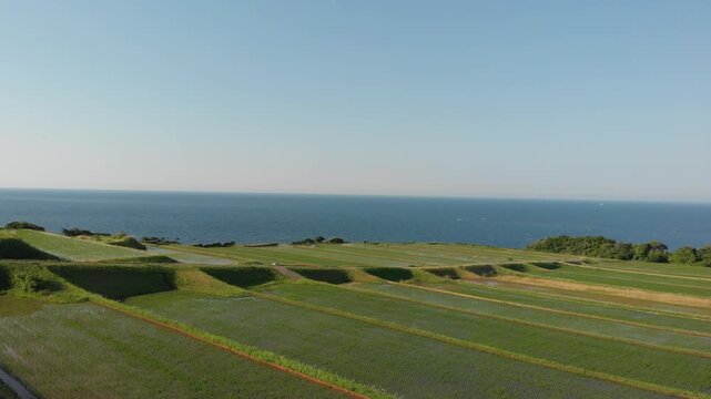 Aerial drone shot rising over the scenic Arai Rice Terraces overlooking the Sea of Japan in Ine, Kyoto