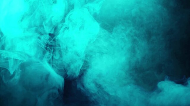 Abstract turquoise smoke swirling and dissipating in dark moody atmosphere