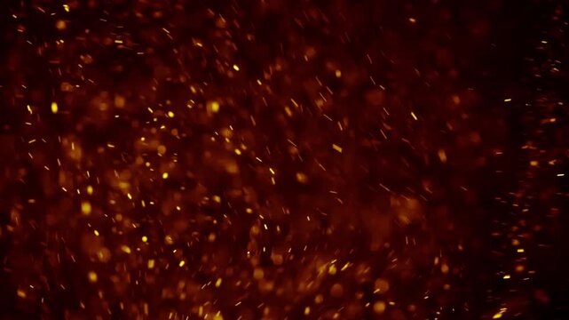 Fiery embers float and dance in the dark, creating a magical and warm atmosphere