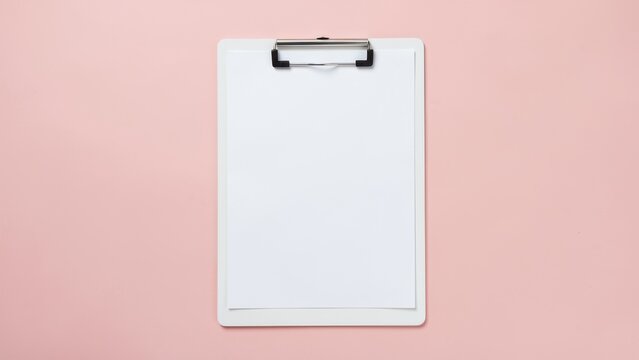 overhead flat lay blank clipboard paper on pastel blush pink background for planning productivity mockups fresh clean organization concept