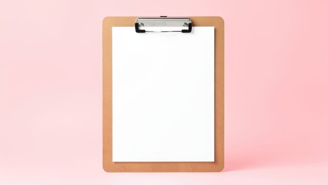 blank white paper on clipboard mockup pastel pink background for productivity planning and fresh start concept studio shot
