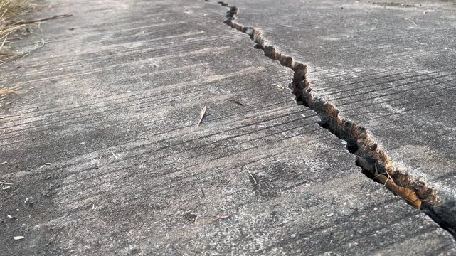 Deep crack on concrete ground texture abstract background of damaged surface