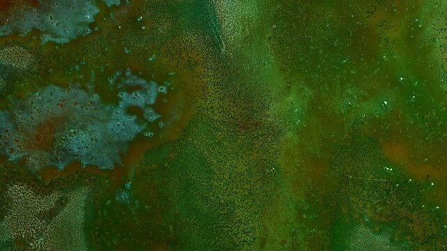 Timelapse of copper oxidation forming colorful green, blue and orange patina. Abstract macro texture showing corrosion, chemical reaction and evolving metallic surface in high detail