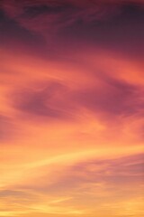 Fototapeta premium Colorful Sunset Sky with Orange Pink and Yellow Clouds Golden Hour Vertical Romantic Background