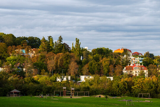 Park Landscape With Trees, Houses and Dramatic Cloudy Sky