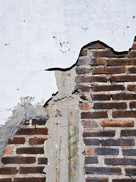 Damaged Brick Wall With Peeling Plaster