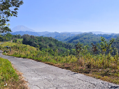 Scenic Landscape with Rolling Hills and Distant Mountain