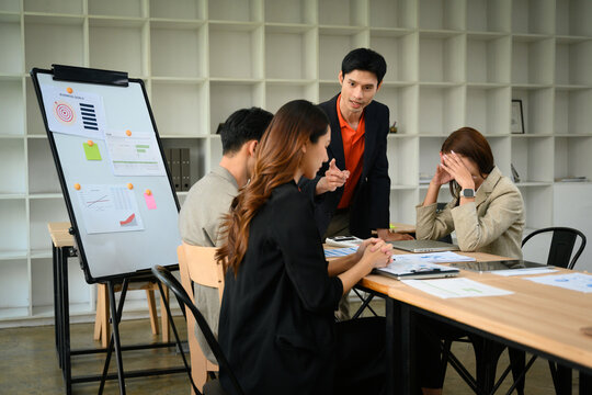 Angry Boss Confronting Team During Business Meeting Over Disrupted Plan and Project Failure in Office