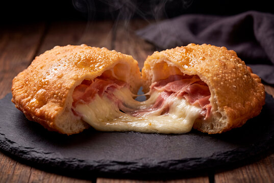 Steaming fried panzerotti with cheese pull