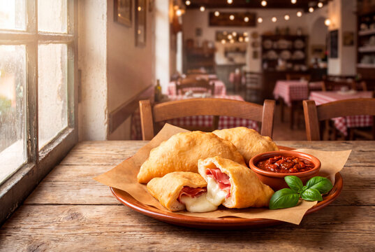 Panzerotti with capocollo in rustic restaurant