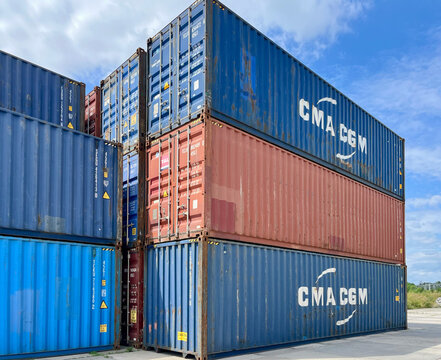 Poland - 07.10.2026: Stack of CMA CGM and UASC Shipping Containers at Container Terminal Under Blue Sky &ndash; Global Logistics, Freight Transportation and International Trade
