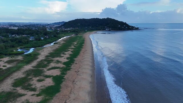 Morning drone flight along a tropical beach and coastline in Remire-Montjoly, French Guiana.