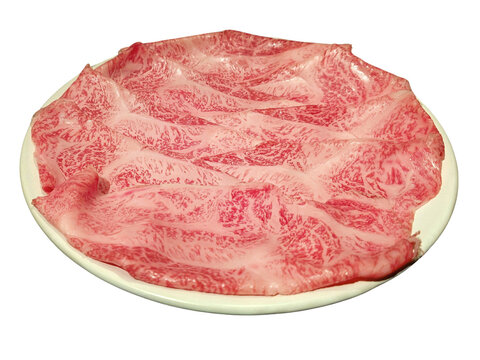 Sliced raw wagyu beef with marbled pattern on white plate