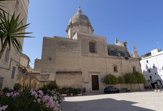 Ostuni cathedral dome dominating historic piazza cattedrale under blue sky