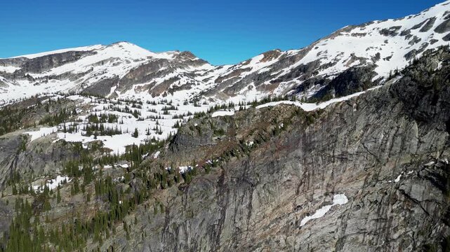 Aerial drone footage reveals Gwillim Lake frozen and snow covered in Valhalla Provincial Park British Columbia.